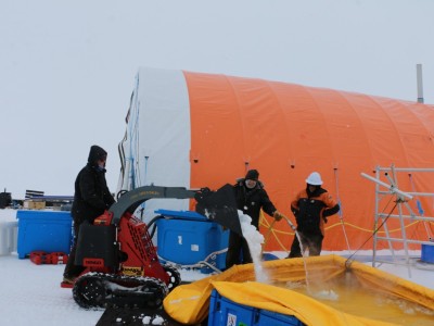 Jane Chewings, Hedley Burge and Tony Kingan melting snow for the hot water drill "flubber"